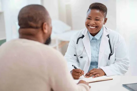 Young doctor taking notes during a consultation