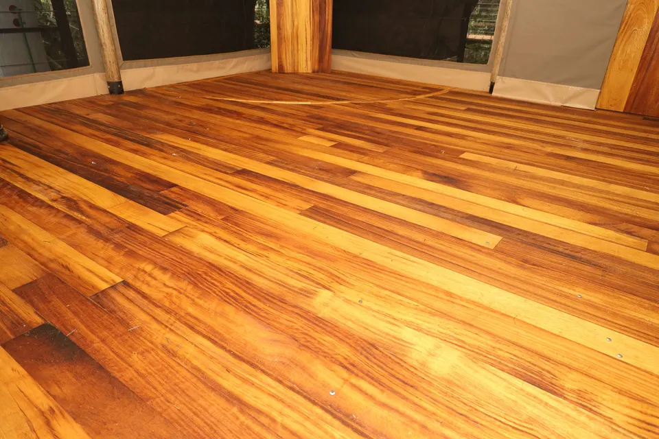 Glossy hardwood plank floor inside a safari tent