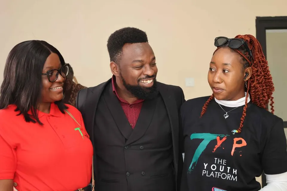 Three smiling young leaders talking at a Youth Platform event
